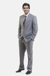 © IndiaPix - Full length portrait of young businessman with hands in pockets standing against white background