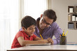 © IndiaPix - Father helping son with homework