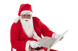 © IndiaPix - Portrait of Santa Claus holding laptop over white background