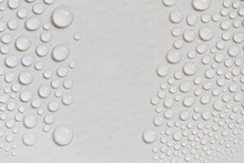 Big And Small Water Drops On Gray Background. Closeup.