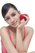 © IndiaPix - Portrait of beautiful woman with apple over white background