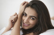 © IndiaPix - Portrait of beautiful young woman smiling in bedroom