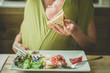 © LoloStock - Mother with baby eating bacon sandwich