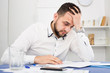 © JackF - Man struggling to pay bills