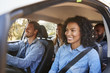 © Monkey Business - Four happy young adult friends in a car on a road trip