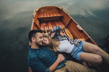 Young Couple Relaxing On A Boat Enjoying Sunny Day