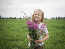 Portrait Of A Little Girl With A Big Bouquet Of Wild Flowers Purple Fireweed