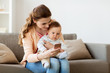 © Syda Productions - happy mother with baby and smartphone at home