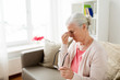 © Syda Productions - senior woman with glasses having headache at home