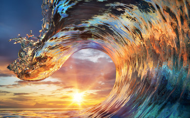 Colorful Ocean Wave. Sea water in crest shape. Sunset light and beautiful clouds on background