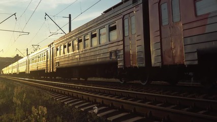 Wall Mural -  passenger train fast running to the sunset