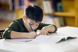 © sirikorn - Happy asian child doing homework with smile face.