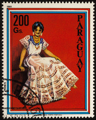 Wall Mural - Young woman in traditional dress on postage stamp