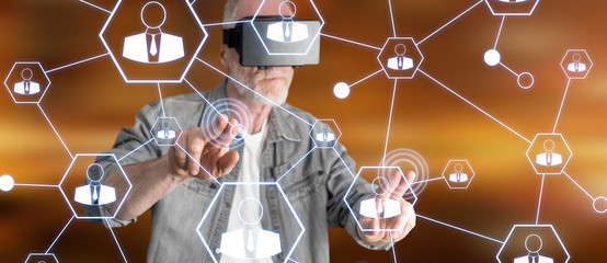 Poster - Man wearing a reality virtual headset touching a social network on a touch screen