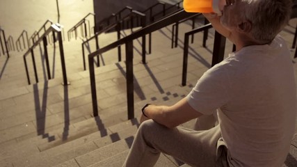 Wall Mural - Pleasant sporty aged man resting after sport activities