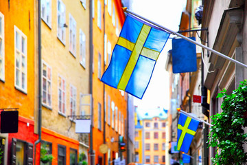 Wall Mural - Street in Stockholm with swedish flags