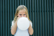 © Jose Luis Carrascosa Martinez/ADDICTIVE STOCK - Girl blowing balloon outside