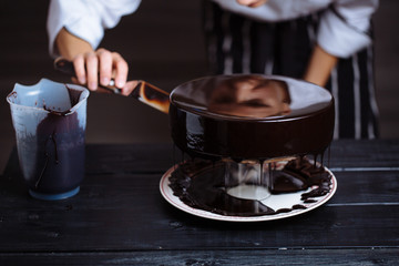 Wall Mural - Glazing chocolate mousse cake, close-up