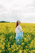 © Денис Кипкаев - Beautiful girl in a dress among yellow flowers in a field