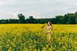 © Денис Кипкаев - Beautiful girl in a dress among yellow flowers in a field