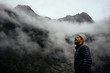 © Christian McLeod Photography/Stocksy - Man in his down jacket looking towards the cold foggy sky as the weather changes