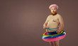 © Studio Romantic - Funny bearded man in inflatable circle measuring waist