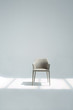 © Miquel Llonch/Stocksy - Beautiful grey chair in the studio