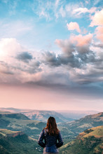 Hiker Overlooking A Scenic Mountainous Valley At Sunset