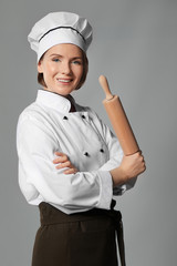 Sticker - Female chef with rolling pin on grey background