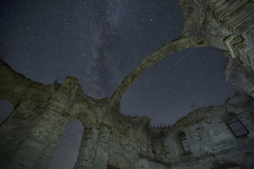 milky way galaxy rising over ancient ruined church at zhrebchevo dam,bulgaria