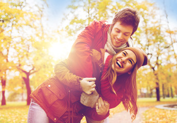 Poster - happy young couple hugging in autumn park