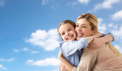 Poster - happy family of girl and mother hugging over sky