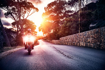 Wall Mural - Motorcyclist in sunset light