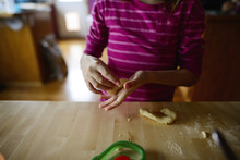 Midsection Of Girl Making Christmas Cookie While Standing At Table