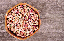 Colored Beans In A Wooden Bowl On An Old Wooden Background