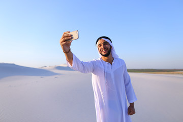 Wall Mural - Portrait of Arabian sheikh man with gadget that communicates in 