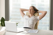 © fizkes - Calm smiling businesswoman relaxing at comfortable office chair hands behind head, happy woman resting in office satisfied after work done, enjoying break with eyes closed, peace of mind, no stress