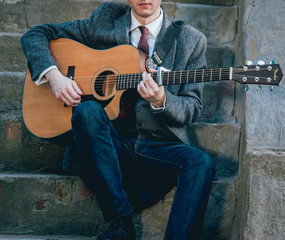 Wall Mural - Man's hands playing acoustic guitar. Background