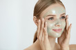 © puhhha - Peeling Beauty Mask. Female Applying Peel Off Mask On Face