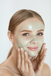 © puhhha - Peeling Beauty Mask. Female Applying Peel Off Mask On Face