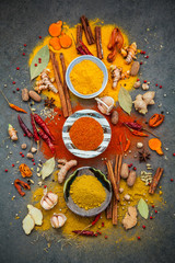 Poster - Various of spices and herbs in ceramic bowl. Flat lay of spices ingredients chilli ,pepper corn, garlic, thyme, star anise, nutmeg, mace, ginger and bay leaves on dark stone background.