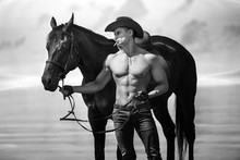 Macho Man Handsome Cowboy And Horse On The Background Of Sky And Water.