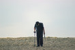 © yarohork - Men walking on beach metal detector.