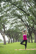 © FAMILY STOCK - Young woman practicing yoga in park