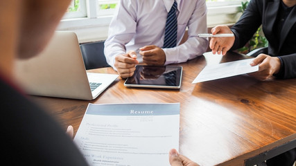 Business men and resume paper for a job interview concept on meeting table in office