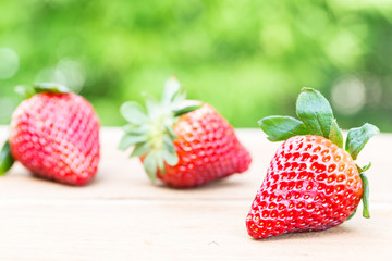 Strawberries with blurry green background