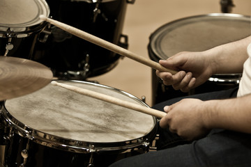 Wall Mural - Hands of a man playing a drum set