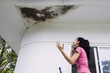© Creativa Images - Depressed woman with damaged ceiling