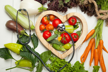 Fresh vegetables. Diet, a healthy lifestyle. Sport, dumbbells and a skipping rope on a white background