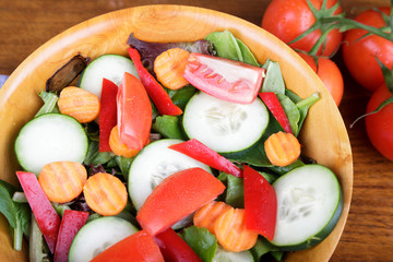 Wall Mural - Large Mixed Salad in Wood Bowl with Fresh Tomatoes